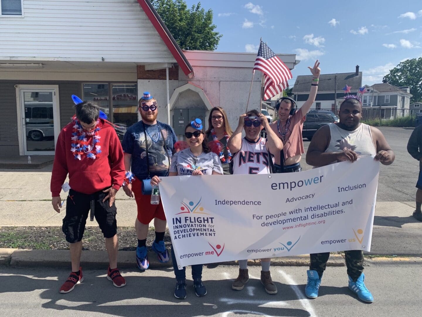 Hudson Flag Day Parade - In Flight, Inc. Programs holding banner