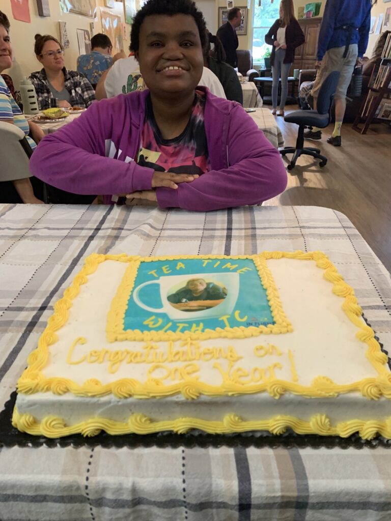 Tiffany celebrating her podcast, Tea Time with TC's, Anniversary with cake!