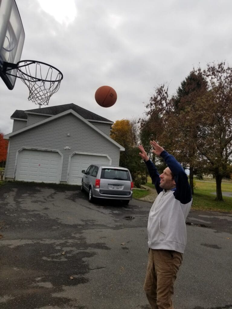 Build Hope by Becoming a Hope Builder for National Developmental Disabilities Awareness Month - Person we support playing Basketball at home